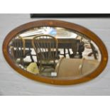 Edwardian mahogany and inlaid oval mirror, 79 x 49cm.