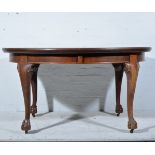 Edwardian walnut dining table, oval wind-out top, moulded edge, plain frieze, carved cabriole legs,