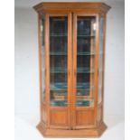 Contemporary oak display cabinet, glazed and panelled doors, enclosing five glass shelves,