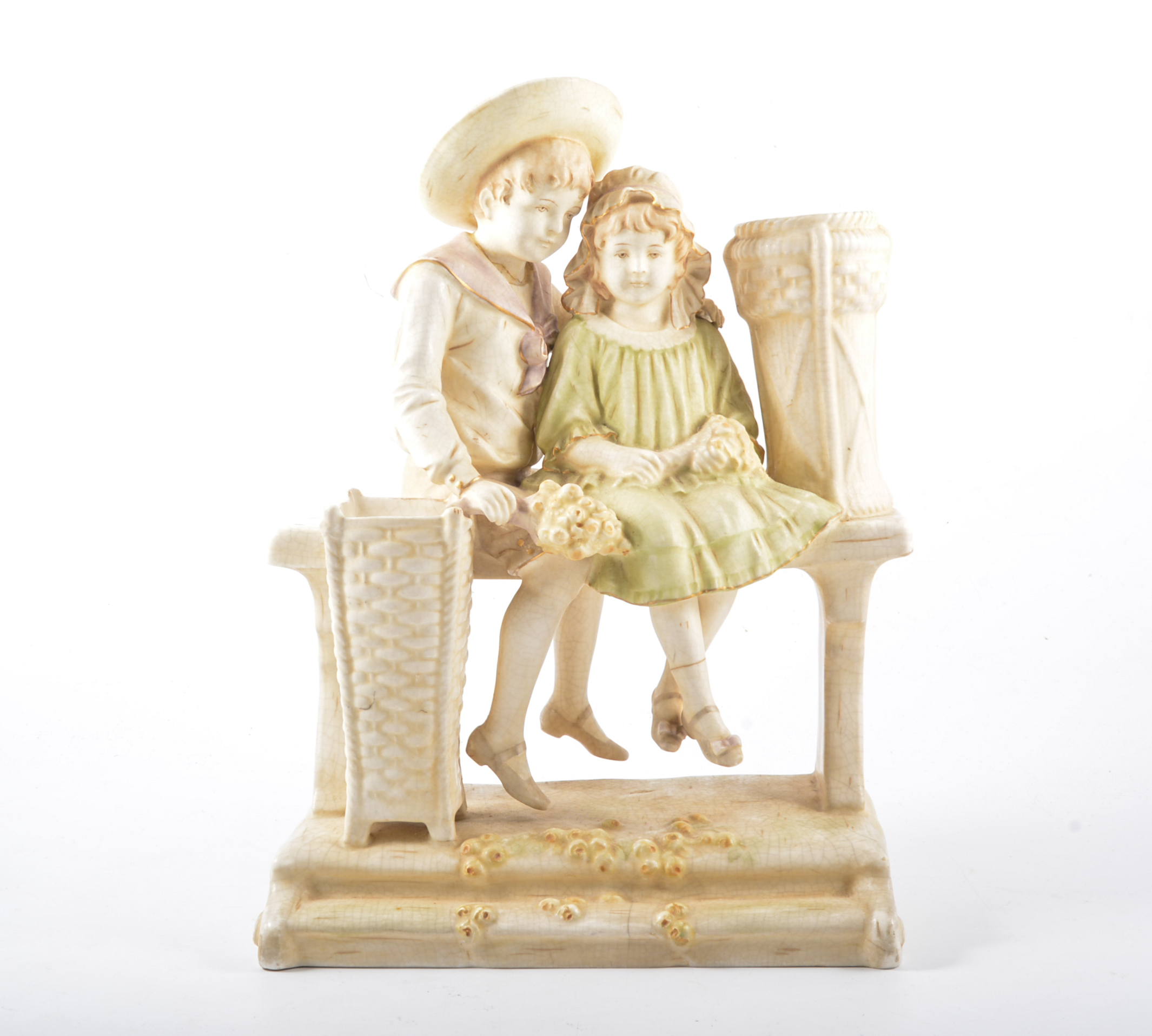 Ernst Wahliss, pottery group of boy and girl on a garden bench, with spill vase aperture,