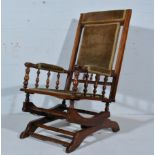 Stained American style rocking chair, upholstered back, arms and seat, turned and ringed rails,