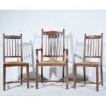 Set of six Edwardian oak dining chairs, shaped crestings, rush drop-in seats, square tapering legs,