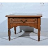 Oak coffee table, rounded square top inset with glass, with single frieze drawer on turned supports,