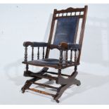 Stained American style rocking chair, upholstered back, arms and seat, blue velour upholstery.