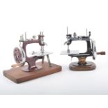 Four small hand sewing machines, a small black "Gold Medal" sewing machine on mahogany base,