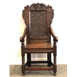 Joined oak armchair, basically late 17th/18th Century, carved oak back with a scrolled cresting,