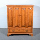 Oak television cabinet, by Haselbech Oak, two bi-fold doors, with arched fielded panels,