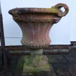 Pair of Haddonstone terracotta two handled urns, fluted bodies, the plinths with fruit swags,