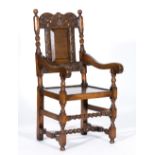 Joined oak elbow chair, 17th Century style, carved cresting, panelled back, scrolled arms,