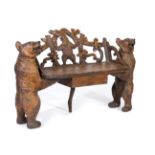 Black Forest carved spruce/pine bench, shaped back, with a vine tendril and standing bear motif,