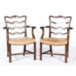 Set of six George III style mahogany elbow chairs, each with pierced wavy ladder backs,
