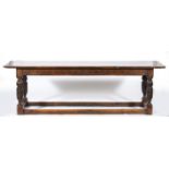 Joined oak table, 18th Century and later, rectangular boarded top with cleated ends, carved frieze,