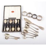A cased set of silver teaspoons, old English design, three silver napkin rings, one plated,