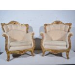 A pair of French gilt wood upholstered armchairs, scrolling framework, arms and legs,