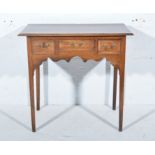 Late Georgian oak side table, rectangular top with moulded edge, three frieze drawers, shaped apron,