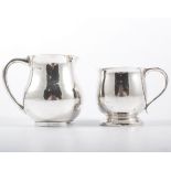 Small beaten silver cream jug, loop handle; and a small silver mug.