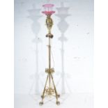 Edwardian brass oil lamp, urn shape form, cranberry glass shade with chimney, height 63cm overall,