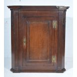 Joined oak corner cupboard, early 19th Century, cavetto moulded cornice, rectangular panelled door,