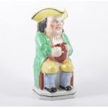 A Staffordshire Toby Jug, modelled with Mr Toby seated, holding a jug of ale, 25cm.