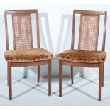 Four teak framed G-Plan dining chairs, cane panel backs, upholstered pad seats, 87cm.
