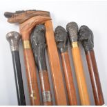 An ebonised walking cane, engraved silver pommel, 91cm and six other walking sticks, (7).