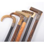 Ebony walking stick, horn handle, silver ferrule, 93cm and four other walking sticks, (5).