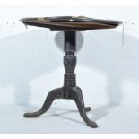 Burmese carved hardwood occasional table, circular tilt top, designed with a Griffin, turned column,