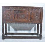 Joined oak credence cupboard, rectangular boarded top, lunette carved frieze,