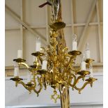 Solid brass Dutch style twelve light chandelier, approx drop 76cm.