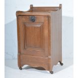 Edwardian oak purdonium, panelled door, width 36cm.