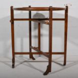 Folding screen/card table, labelled Revertable, folding stand, diameter 66cm overall.