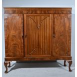 Mahogany side cabinet, central panelled cupboard flanked by further cupboards, raised on pad feet,