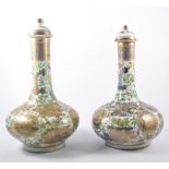 Pair of Chinese porcelain bottle vases, each with a domed cover, bulbous body and circular foot rim,