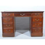Edwardian walnut twin pedestal desk, nine drawers surrounding the kneehole,