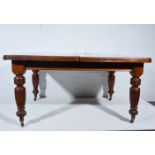 Late Victorian walnut exending dining table, with two additional leaves, complete with winder,