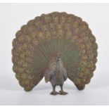 A late 19th/early 20th century cold painted bronze figure of a standing peacock, height 8cm.