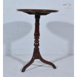 Mahogany tripod table, early 19th Century, with a circular top with a moulded edge, turned column,