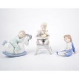 Lladro model of toddler in high chair and two Nao models of young children,