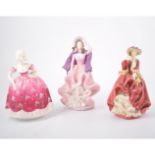 Royal Worcester figure Queen Elizabeth II, three Doulton figures, three Coalport figures,