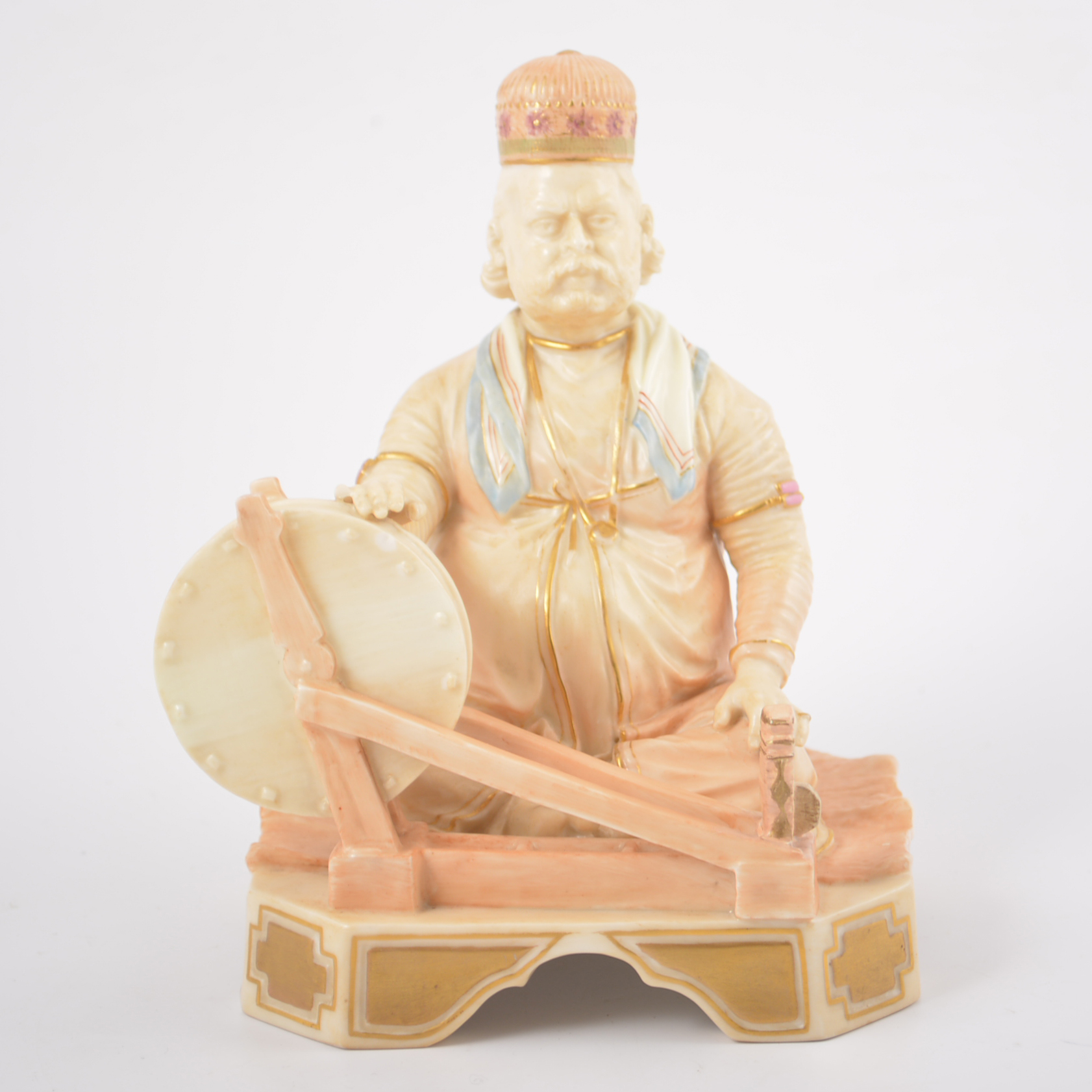 Royal Worcester model Shaban 1203, seated man with a grinding stone, restored, 17cm.