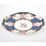 Worcester dish, shaped form, panels of flowers on a blue scale ground, 23cm, script W mark,