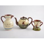 A collection of motto ware by Watcombe Pottery, Dartmouth, Torquay etc, teapots, dishes, mugs, jugs,