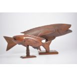 A "Pitcairn Island" carved wooden fish 33cm long on a rectangular stand, 17cm high,