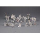 A collection of nineteen Swarovski crystal animals complete with small glazed display cabinet.