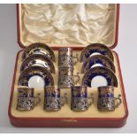A Mappin & Webb Staffordshire eggshell coffee set with silver cup holders,