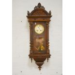 Walnut and beechwood Vienna wall clock, white enamelled dial, movement striking on a gong,