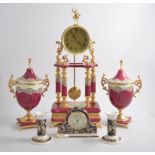 A large modern ceramic clock garniture in the traditional style, cerise and gilt with floral panels,