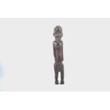 African carved wooden ancestor figure, male form with hands resting on ample abdomen, possibly Luba,