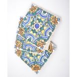 A collection of Spanish terracotta tiles, blue and yellow stylised floral pattern.