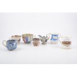 Staffordshire transferware jug; Derby pattern blue and white shell moulded jug; other jugs and mugs.